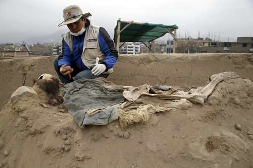 Archeologists work at the site where 16 tombs belonging to 19th century Chinese immigrants were discovered