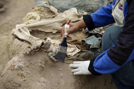 An archeologist works at the site where 16 tombs belonging to 19th century Chinese immigrants were discovered