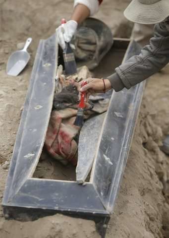 Click to enlarge An archeologist works at the site where 16 tombs belonging to 19th century Chinese immigrants were discovered