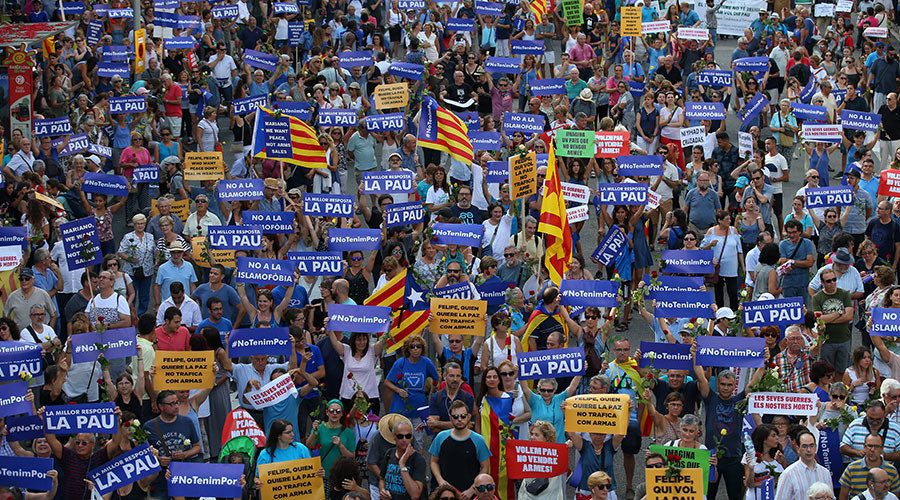 Click to enlarge People hold placards and flag as they take part in a march of unity after last week attacks, in Barcelona