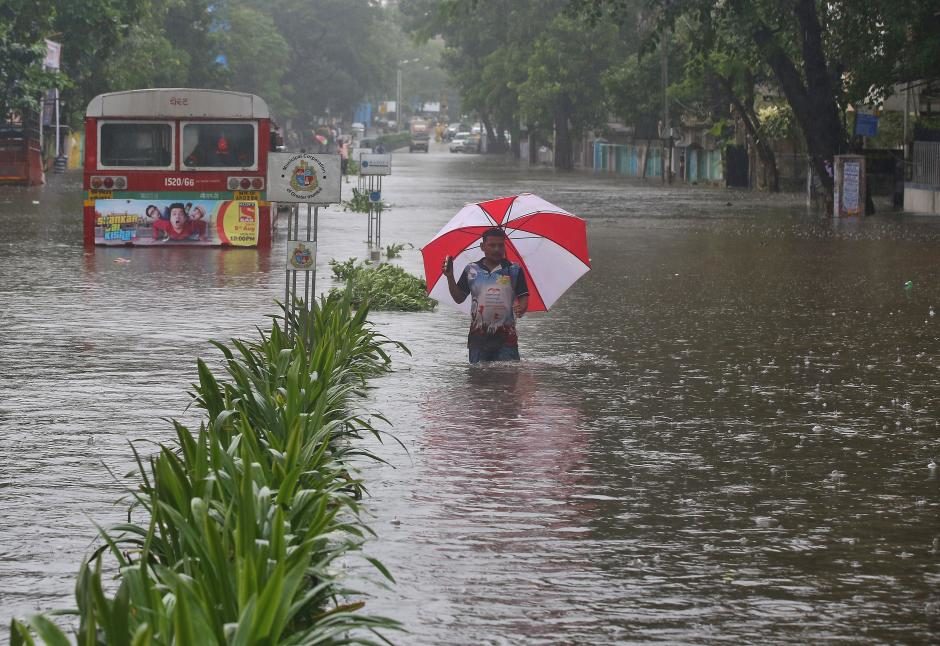 Click to enlarge A man wades through a water-logged road during rains in Mumbai, India, August 29, 2017.