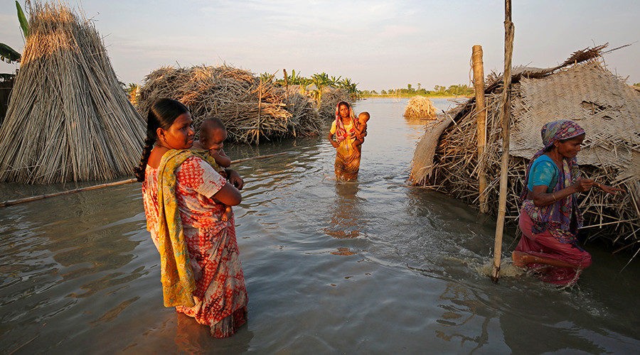 women carry children Bangladesh floods