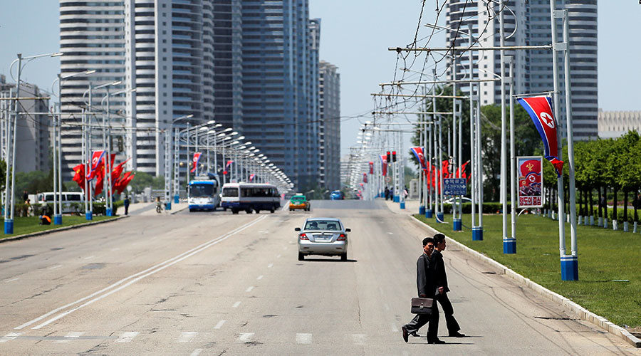 People cross a street in central Pyongyang, North Korea