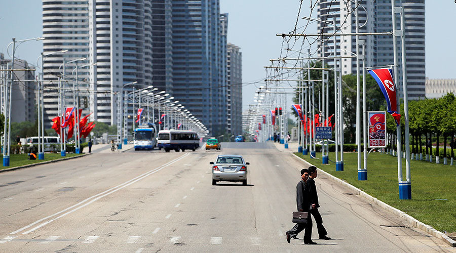 Click to enlarge People cross a street in central Pyongyang, North Korea