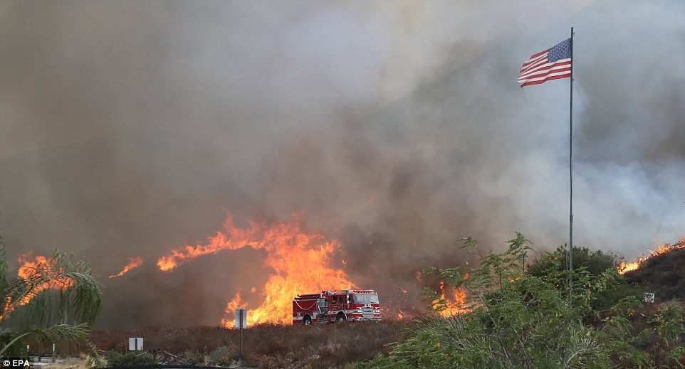 Click to enlarge LAFD on scene responding to fire along La Tuna Canyon Road near Burbank where flames devour a hill