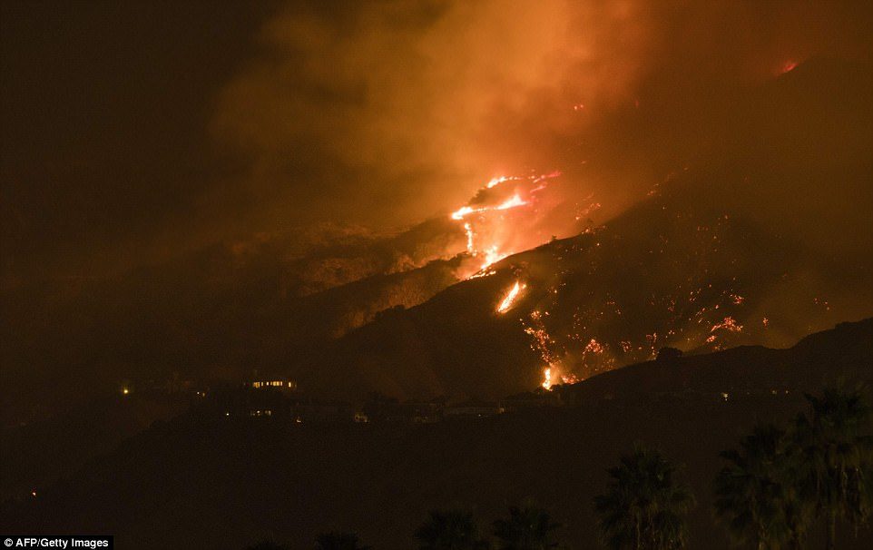 Click to enlarge The La Tuna Canyon fire burns in the hills above Burbank early Saturday as the fire marches along hillsides