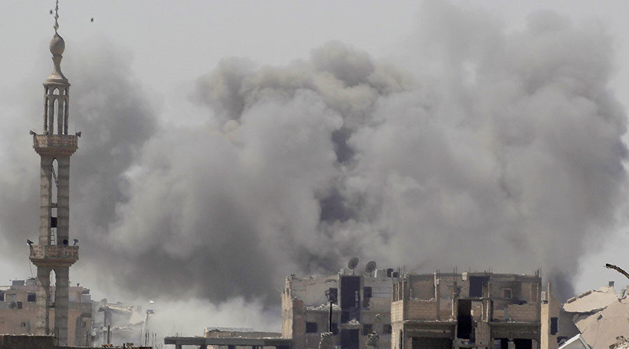Click to enlarge Smoke rises after an air strike during fighting between members of the Syrian Democratic Forces and Islamic State militants in Raqqa