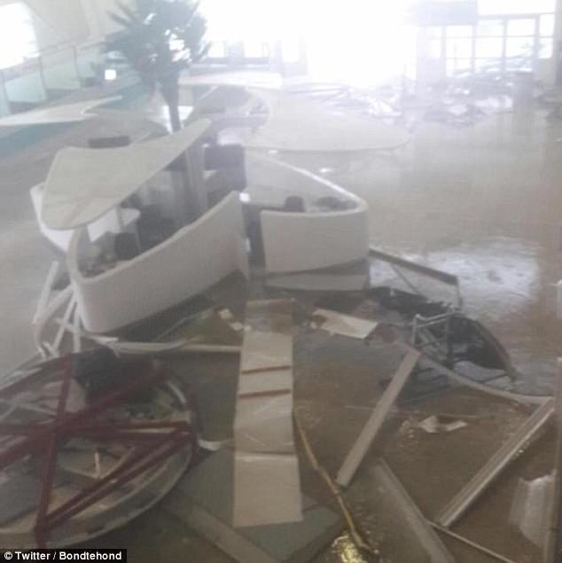 Click to enlarge Huge rocks smashed into planes, and boarding walkways were slammed to the ground by the downpour of rain and gusts of wind, which also brought loads of sand on to the runway