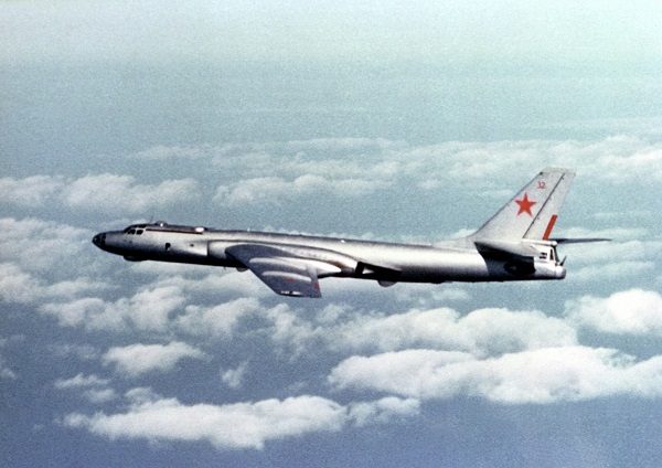 Air-to-air left side view of a Soviet TU-16 Badger E aircraft