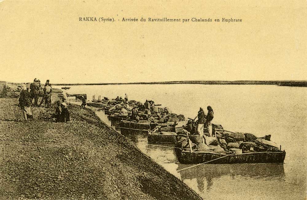 Click to enlarge Boats carrying supplies docked on the banks of the Euphrates River near Raqqa.