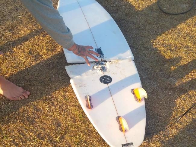 Click to enlarge Mr McGrath’s surfboard was snapped in half.