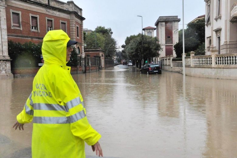 A police officer stands in a flooded crossing in Livorno, Italy, on Sept 10, 2017.