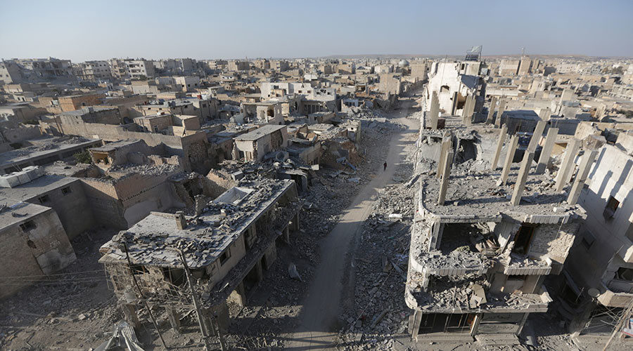 Click to enlarge People walk along a damaged neighbourhood in the northern Syrian town of al-Bab, Syria