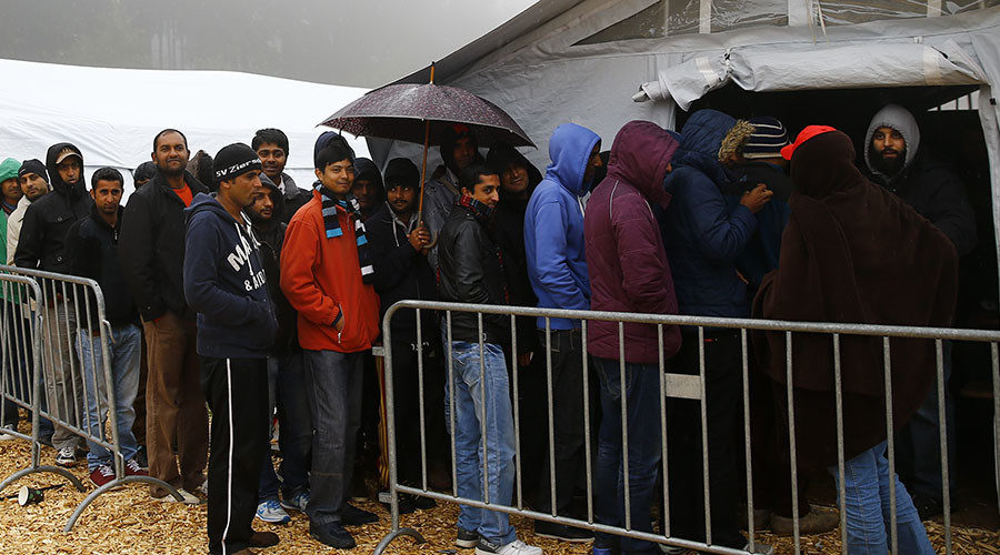 Click to enlarge Migrants queue to get into a food tent at a temporary registration centre in the village of Schwarzenborn, northeast of Frankfurt