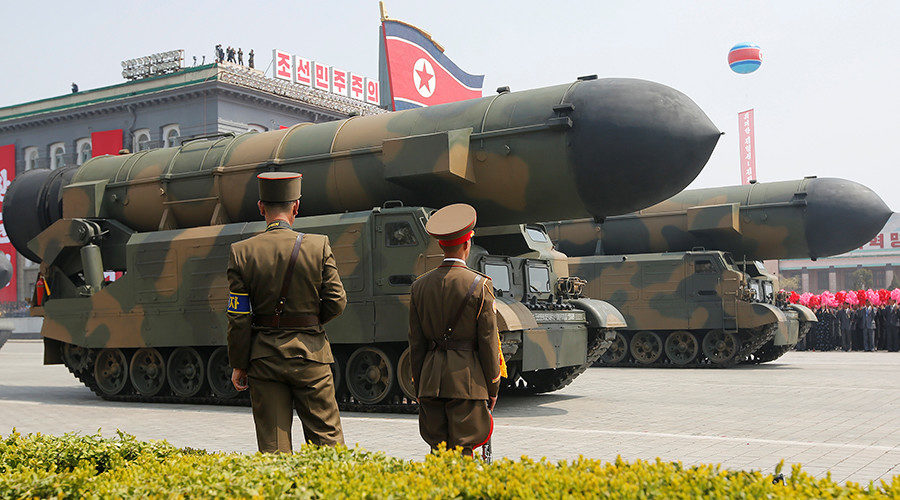 Missiles are driven past the stand with North Korean leader Kim Jong Un during a military parade, Pyongyang