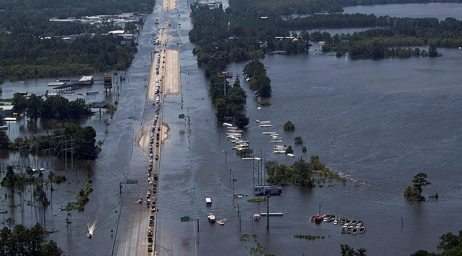 Vehicles on Interstate 10 navigate through flood waters caused by Tropical Storm Harvey in Vidor, Texas, U.S. August 31, 2017.
