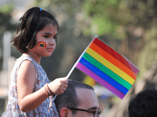 child with pride flag