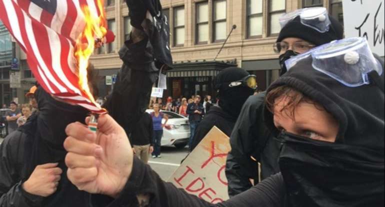 antifa protesters burn flag