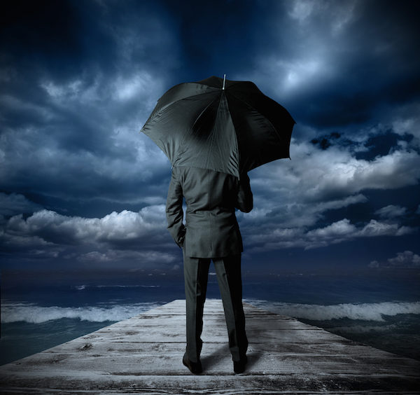 man with umbrella storm