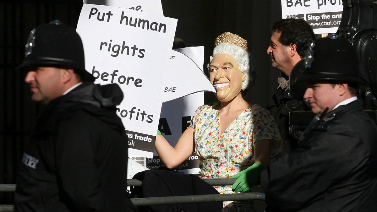 A protestor dressed as Queen Elizabeth II