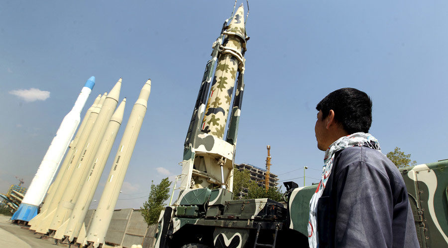 A man looks at Iranian-made missiles