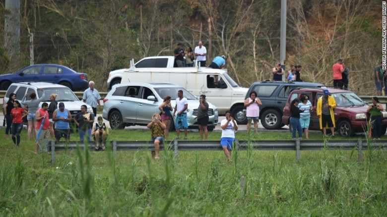 Click to enlarge People attempt to get cellphone signal Puerto Rico.