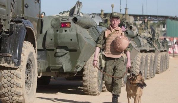 Russian soldier walking with dog