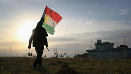man holding kurdish flag