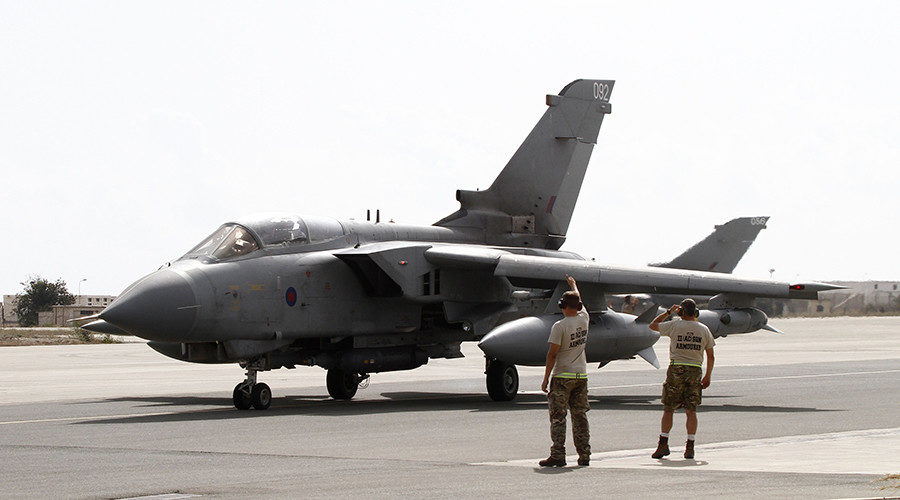 Servicemen stand near a British Tornado jet