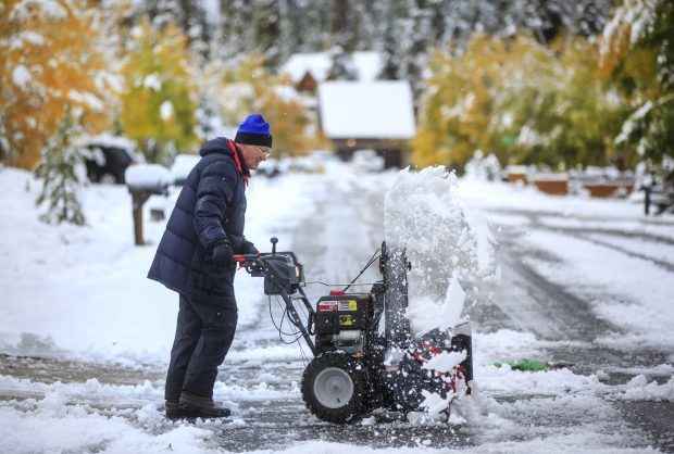 Summit county resident Ron Gilligan clears snow off his driveway in the Summit Cove neighborhood Monday, Oct. 2 near Dillon.