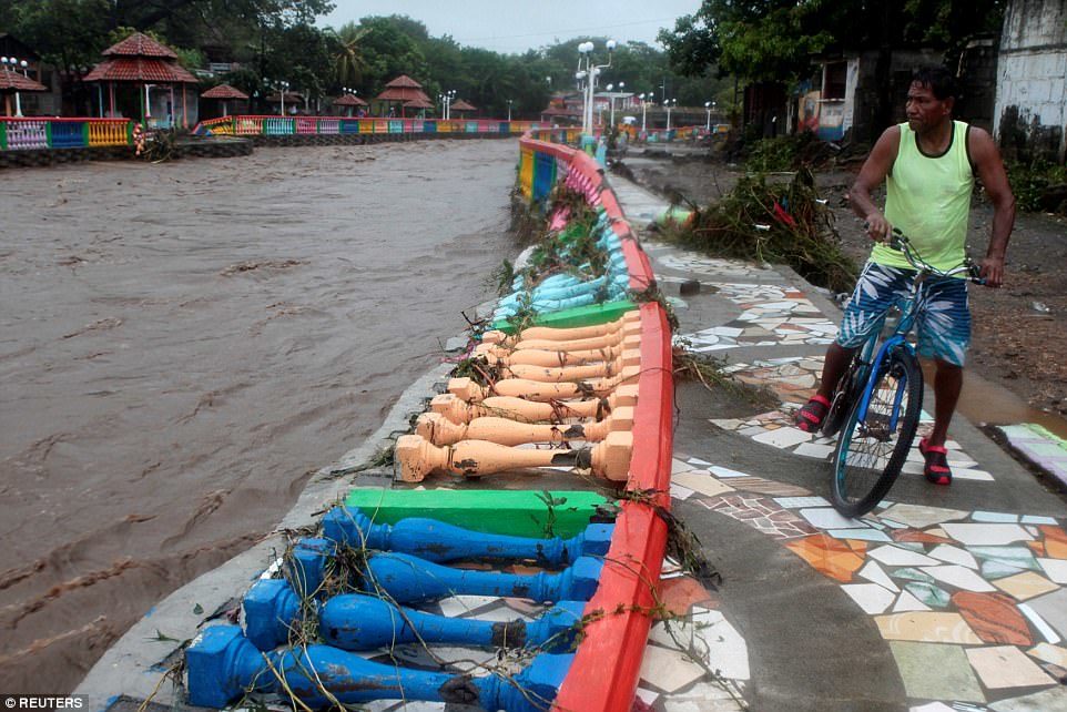 A resident looks at damage caused by heavy rains of Tropical Storm Nate on Masachapa river in outskirts of Managua, Nicaragua