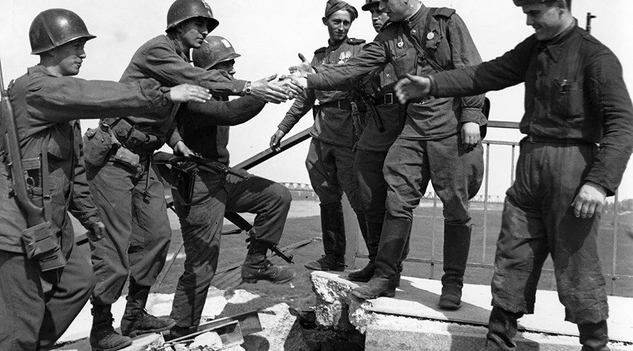 US troops of the 69th Infantry Division (left), shake hands with Russian troops