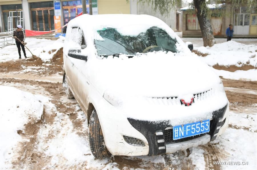 A car is covered by snow in Linxia Hui Autonomous Prefecture, northwest China's Gansu Province, Oct. 9, 2017