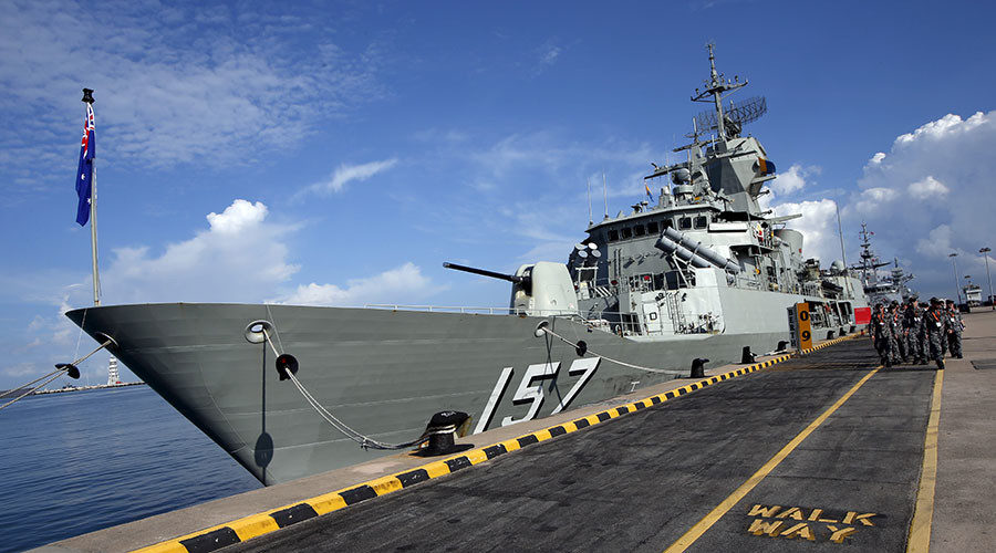 Australian navy personnel march past their HMAS Perth Anzac class frigate on display ahead of the IMDEX Asia maritime defence exhibition at Changi Naval Base