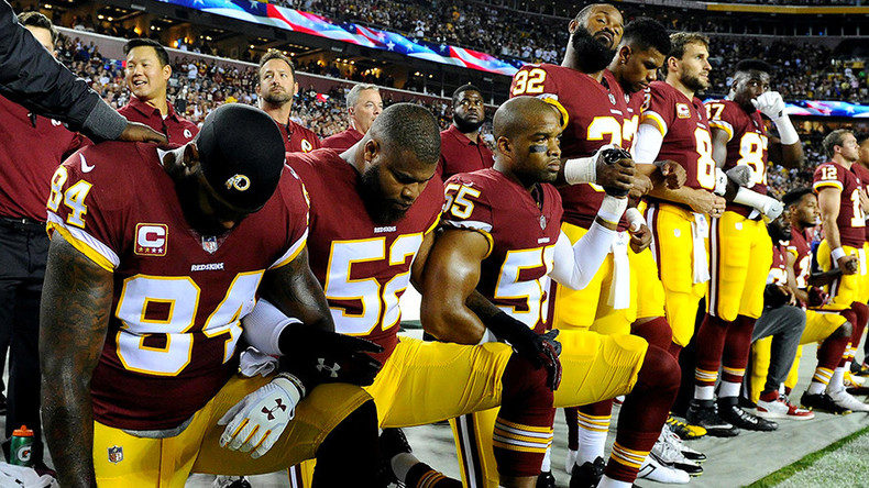 Click to enlarge kneeling footballers