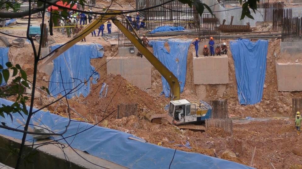 Rescue officers will have to excavate a 35m heap of earth in order to rescue those trapped.