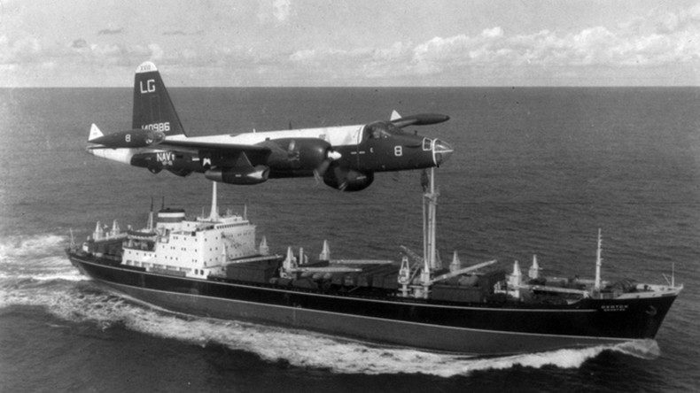 A US Navy P-2H Neptune of VP-18 flying over a Soviet cargo ship with crated Il-28s on deck during the Cuban Crisis