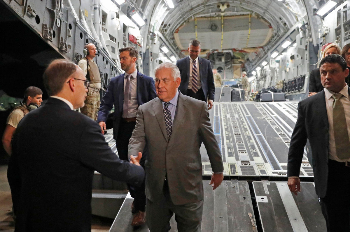 U.S. Secretary of State Rex Tillerson, center, is greeted as he disembarks a plane at Baghdad International Airport on Oct. 23, 2017.