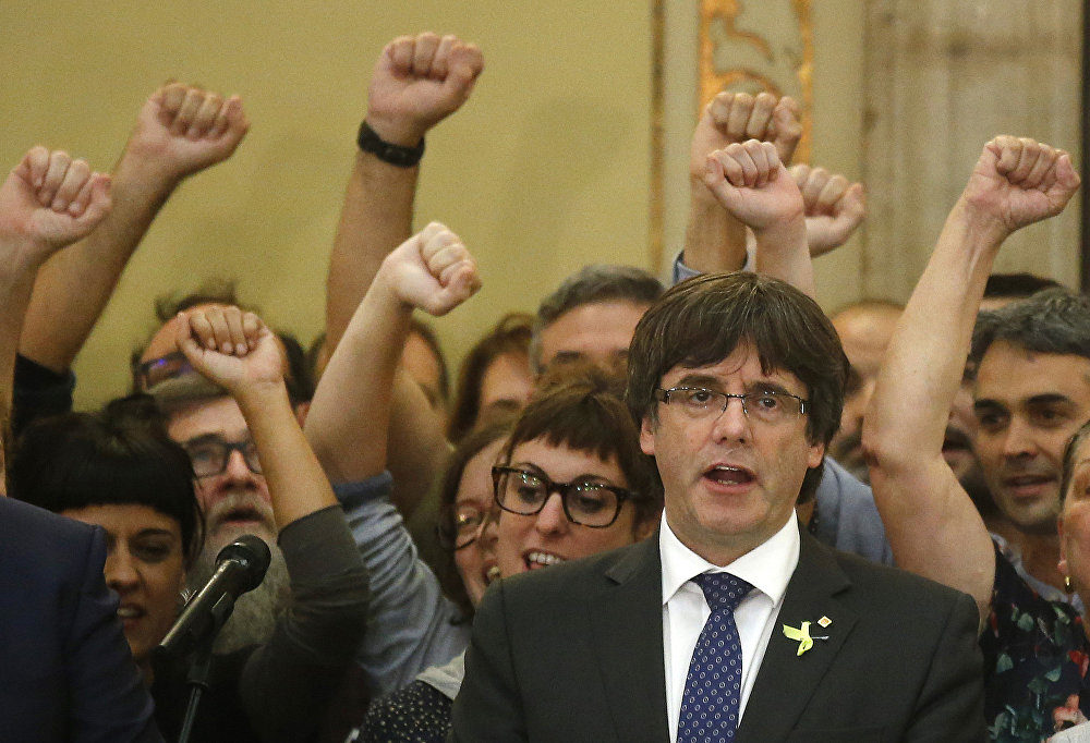 Catalan President Carles Puigdemont sings the Catalan anthem inside the parliament after a vote on independence in Barcelona, Spain, Friday, Oct. 27, 2017.