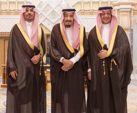 Saudi King Salman bin Abdulaziz Al Saud poses for a photo with National Guard Minister Khaled bin Ayyaf and Economy Minister Mohammed al-Tuwaijri during a swearing-in ceremony in Riyadh, Saudi Arabia, November 6, 2017.