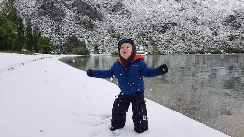 Jakob Williams (2) plays in the snow on the shores of Lake Wakatipu at Kingston