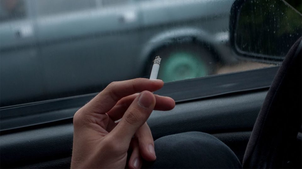 Person smoking in a car