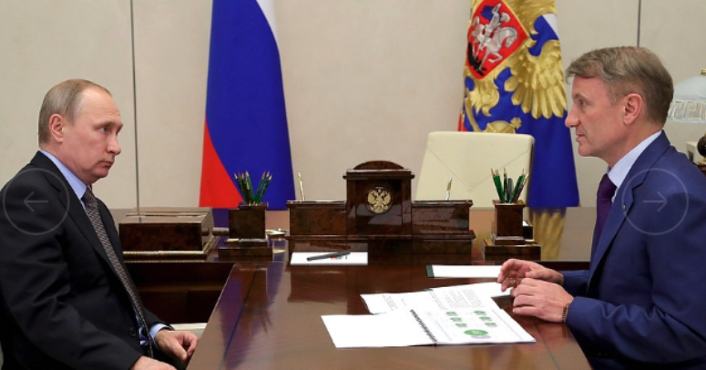 Sberbank chief executive German Gref briefs President Vladimir Putin