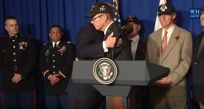 Click to enlarge Trump hugs vet