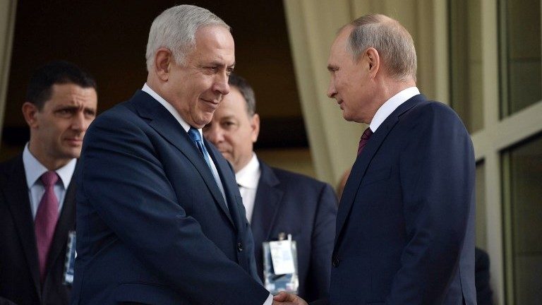 Russian President Vladimir Putin (R) shakes hands with Prime Minister Benjamin Netanyahu during their meeting in Sochi on August 23, 2017.