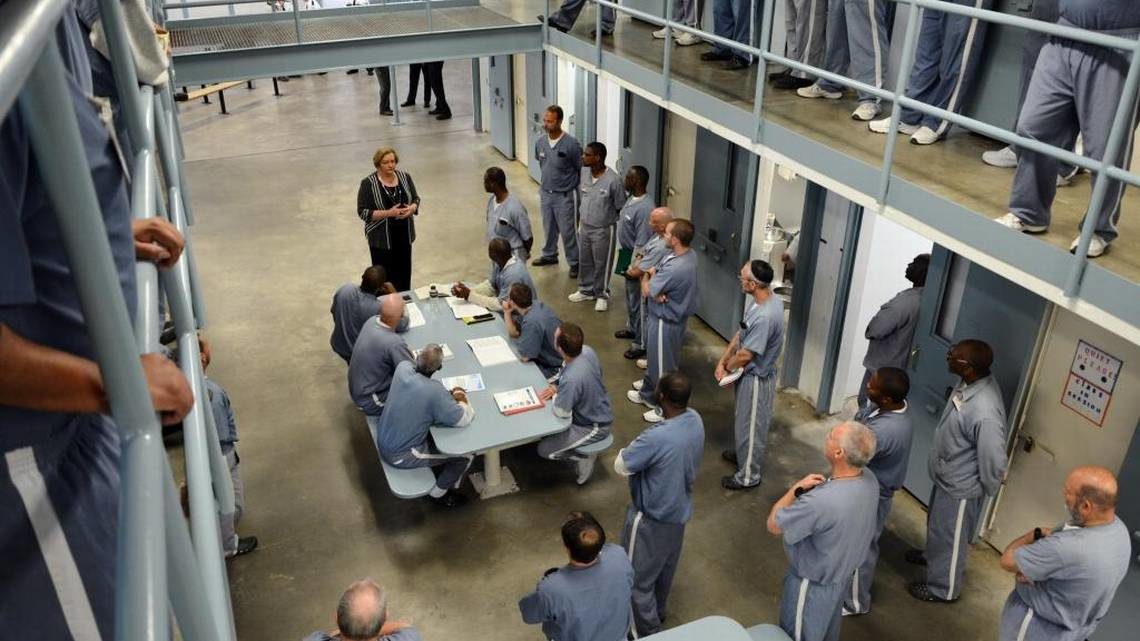 Click to enlarge Julie Jones visits with inmates
