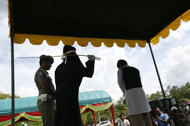 Click to enlarge woman getting caned sharia law 4