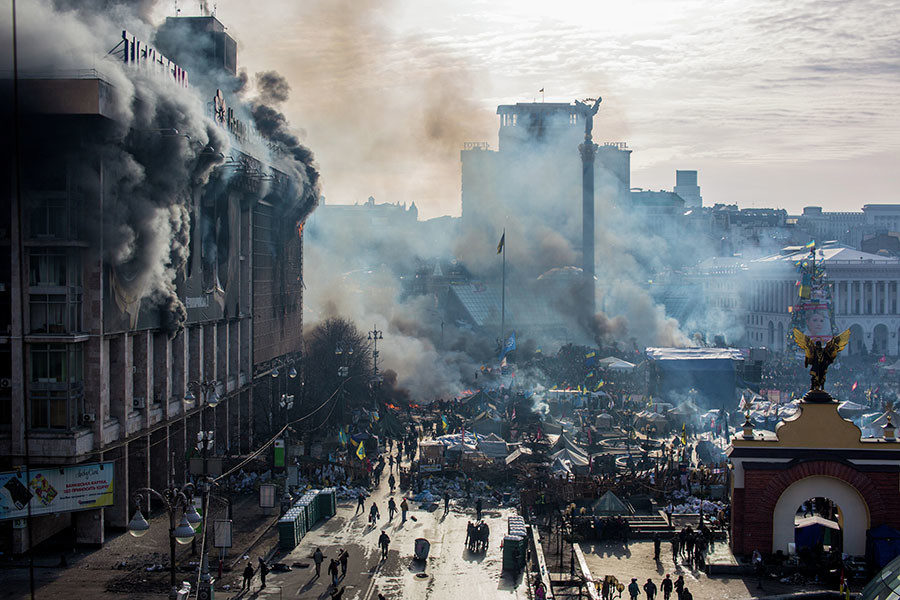 Smoke and opposition supporters on Maidan Square