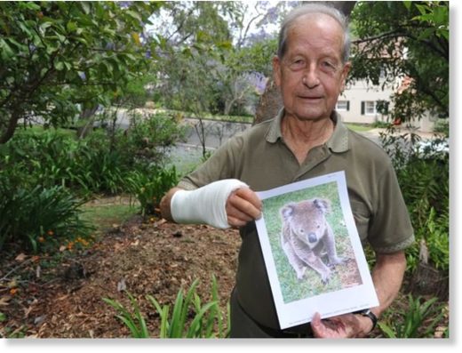 Mr Barnett with a photo of his attacker.
