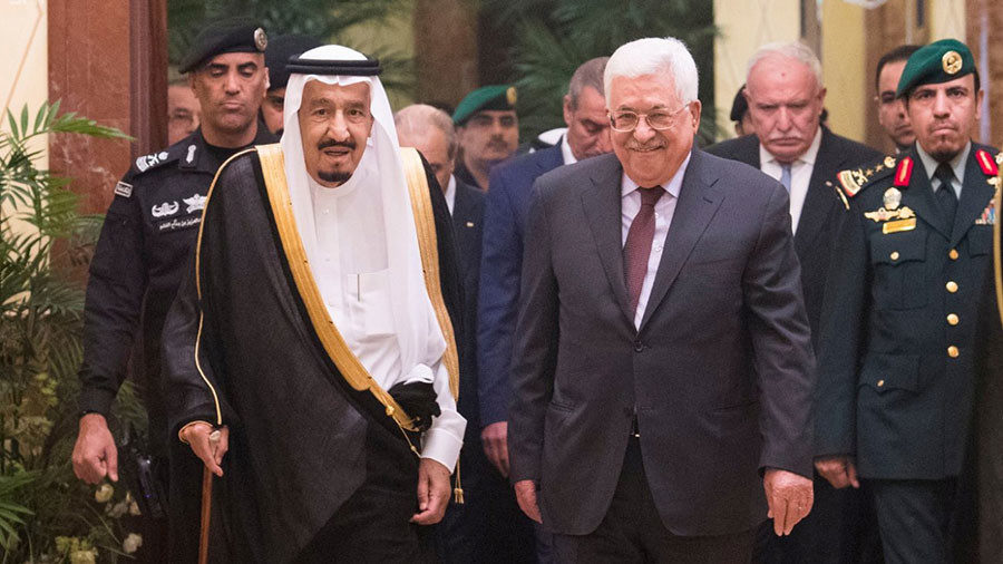 Saudi Arabia's King Salman bin Abdulaziz Al Saud walks with Palestinian President Mahmoud Abbas